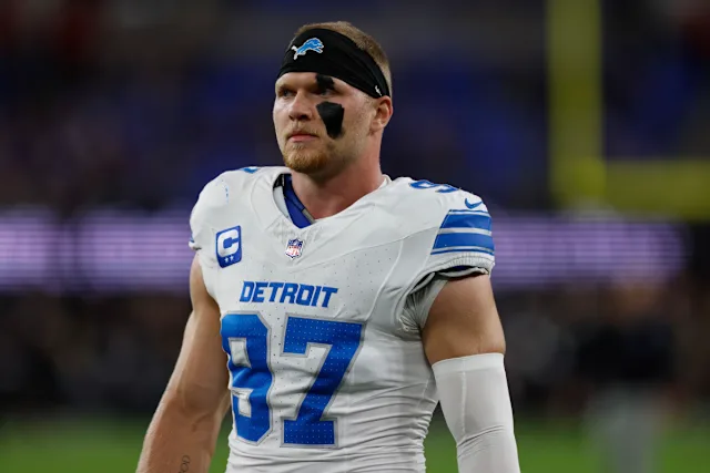 man wearing white football jersey and black headband